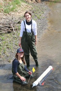 Students Halya Petzold (back) and Brittany McWhirter (front) examine sediment traps in the South Tobacco Creek Watershed. Image by David Lobb