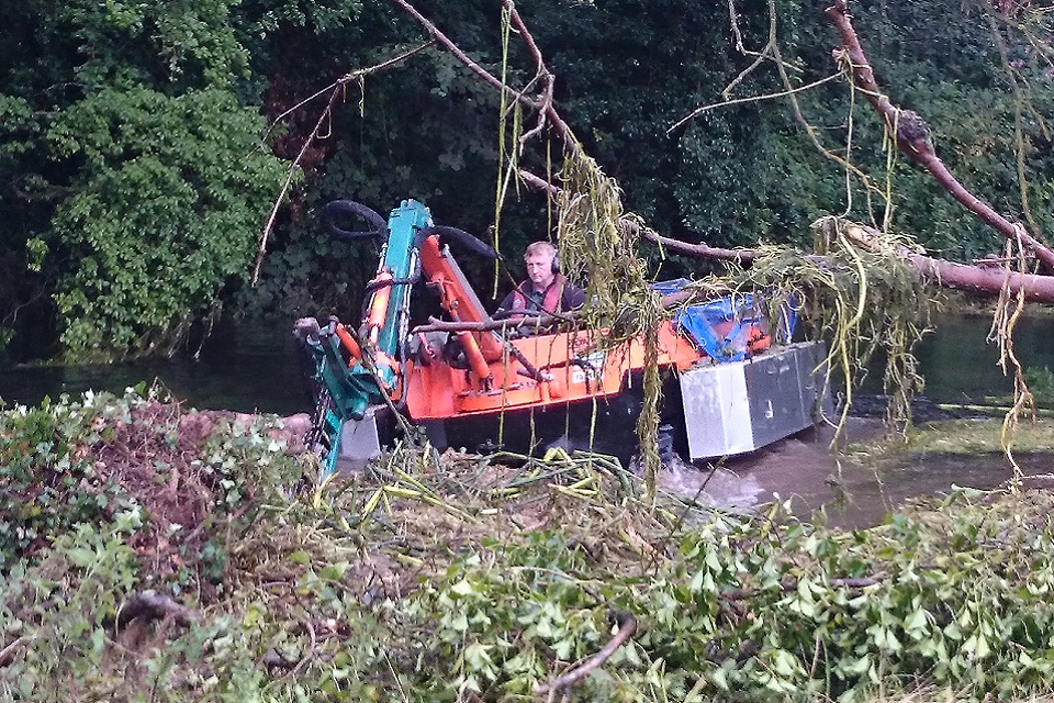 The Amphibious weed cutting boat in action. Image from the UK Environment Agency