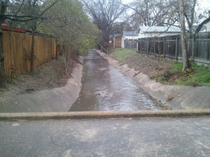 The City of Austin monitors waterways affected by a variety of land uses, including this cement-lined channel in a residential neighborhood. Image credit: COA-WPD-WQM